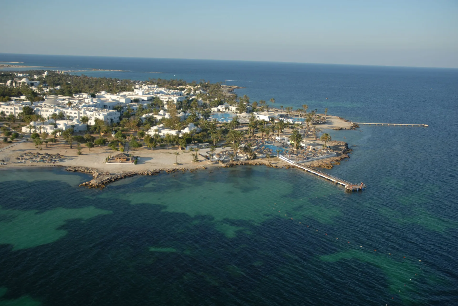 Aerial view of the Djerba coastline, beach and traditional white seaside architecture